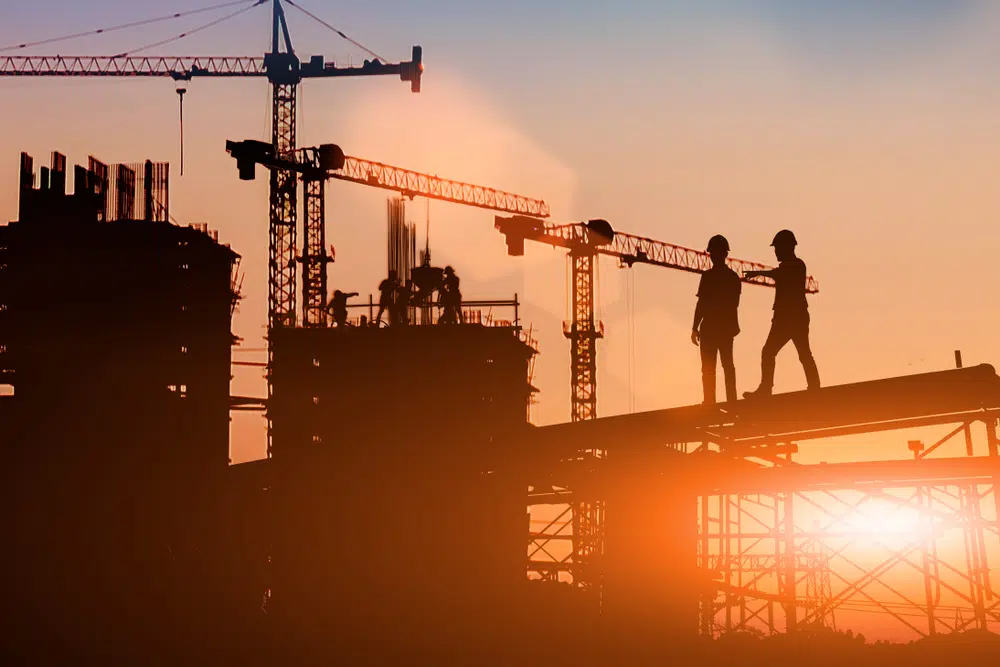 Silhouette,Two,Engineers,Consult,And,Inspect,High-rise,Construction,Work,Over construction jobs