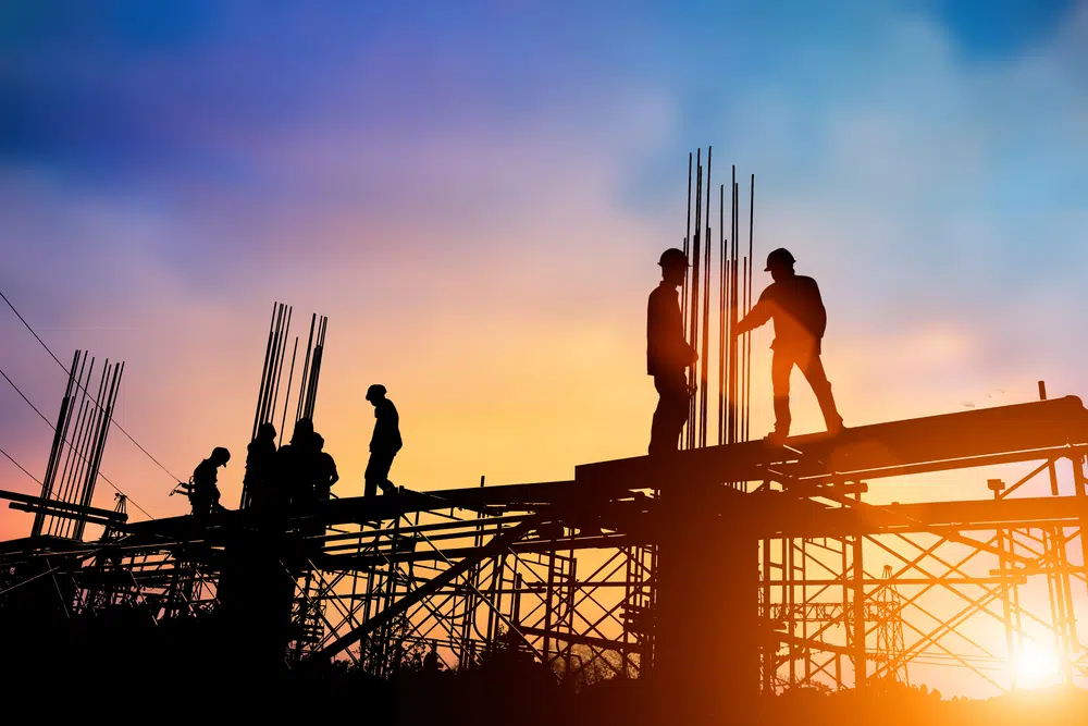 Silhouette,Engineer,Standing,Orders,For,Construction,Crews,To,Work,On construction jobs